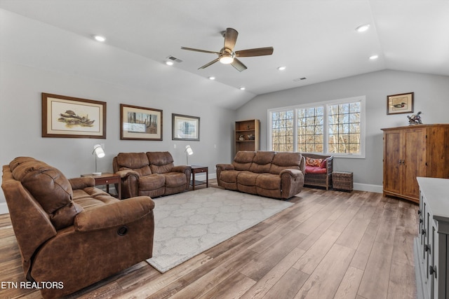 living room featuring light wood-type flooring, vaulted ceiling, and ceiling fan