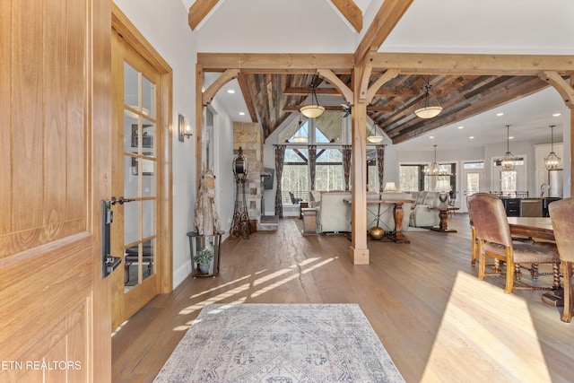 entrance foyer with french doors, beamed ceiling, and hardwood / wood-style flooring