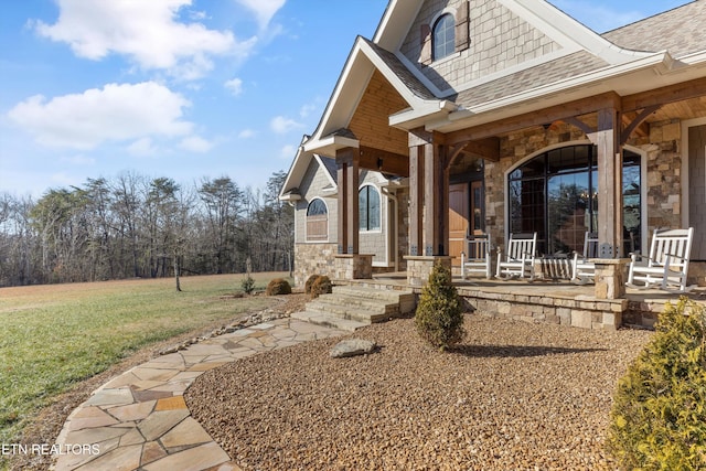 view of front of home featuring covered porch and a front yard