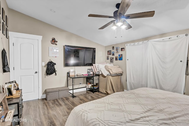 bedroom featuring vaulted ceiling, wood-type flooring, and ceiling fan