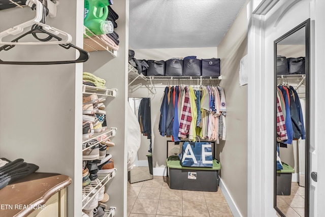 walk in closet featuring light tile patterned flooring