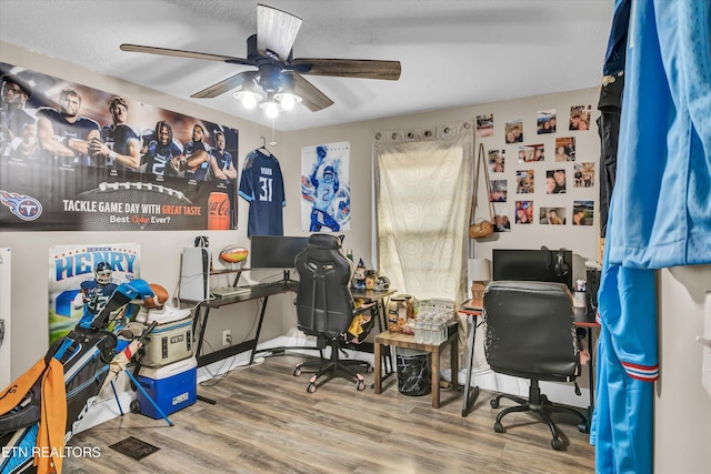 office with hardwood / wood-style flooring and ceiling fan