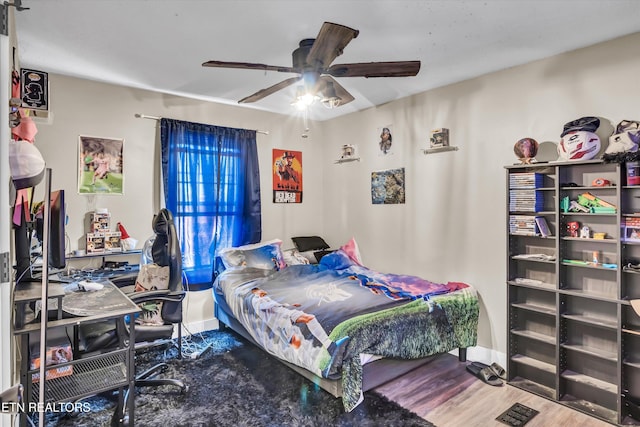 bedroom featuring ceiling fan and hardwood / wood-style floors