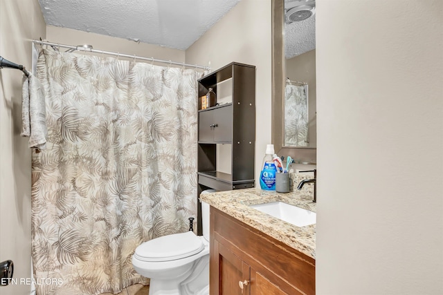 bathroom featuring vanity, toilet, and a textured ceiling