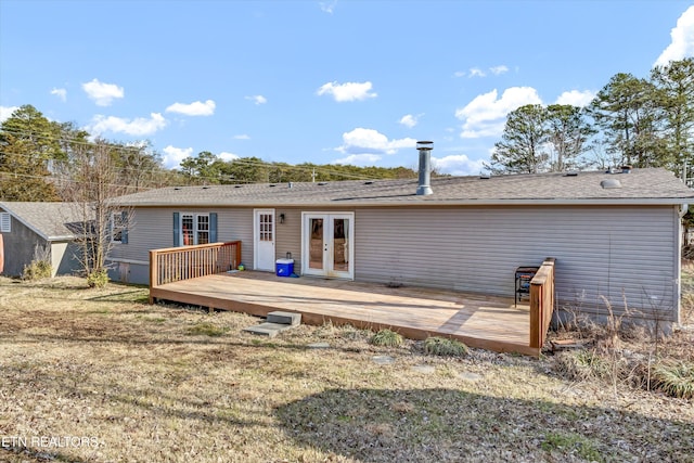 back of property featuring french doors, a yard, and a wooden deck