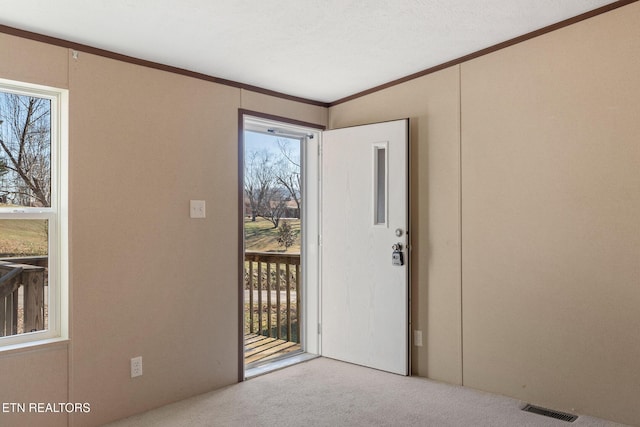 empty room with light colored carpet and ornamental molding