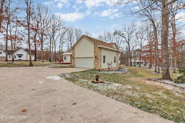 view of side of property with a yard and a garage