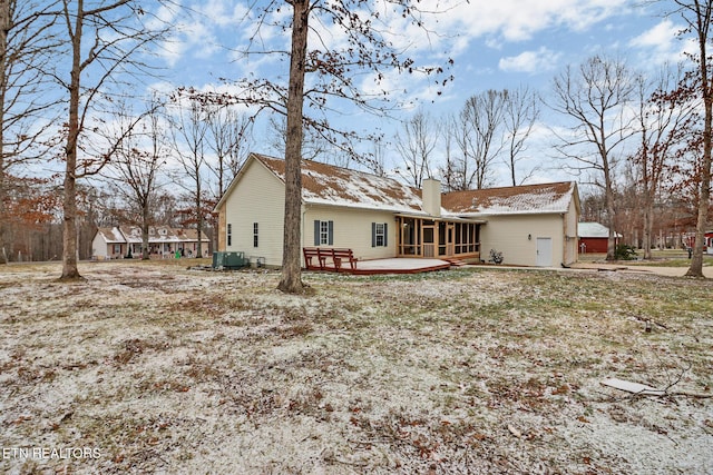 rear view of house featuring a wooden deck, a sunroom, and cooling unit