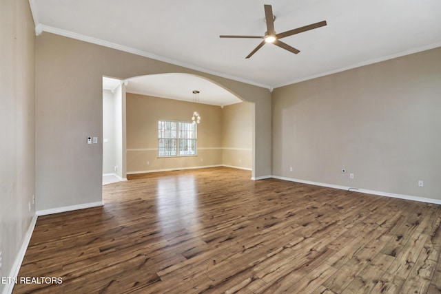 empty room featuring ceiling fan with notable chandelier, hardwood / wood-style flooring, and ornamental molding