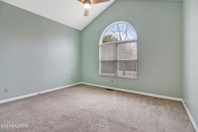 spare room featuring carpet, ceiling fan, and lofted ceiling