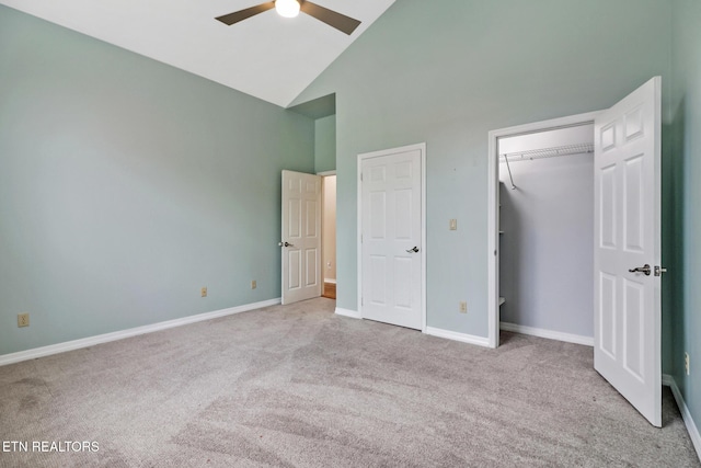 unfurnished bedroom with ceiling fan, light carpet, and high vaulted ceiling