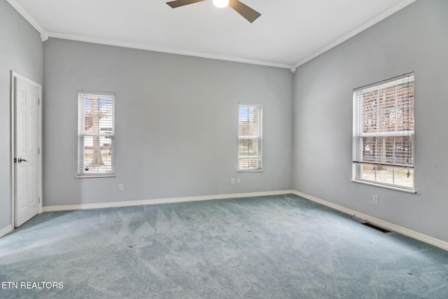 carpeted empty room with ceiling fan, a healthy amount of sunlight, and ornamental molding