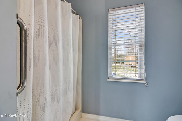 bathroom with a shower with shower curtain