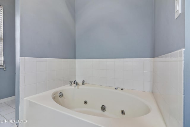 bathroom with tile patterned floors and a bathtub