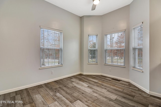 unfurnished room featuring hardwood / wood-style flooring and ceiling fan