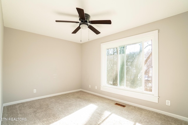 carpeted empty room with ceiling fan