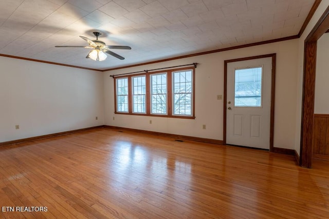 foyer entrance with crown molding, light hardwood / wood-style floors, and ceiling fan