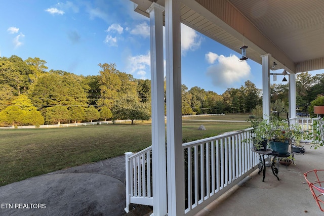 view of patio with a porch and a wooded view