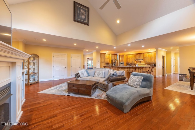 living room featuring high vaulted ceiling, baseboards, ornamental molding, and dark wood-style flooring