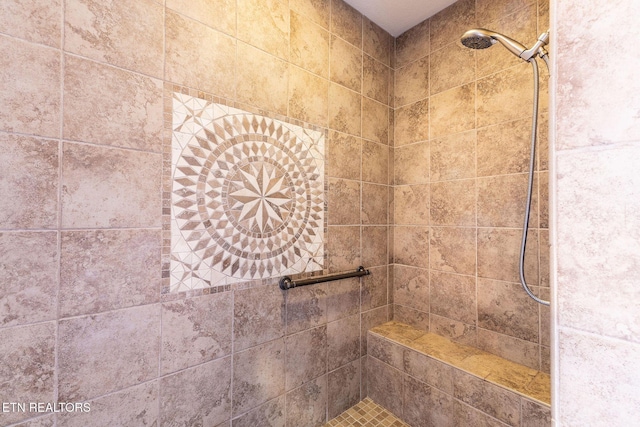 bathroom with tiled shower