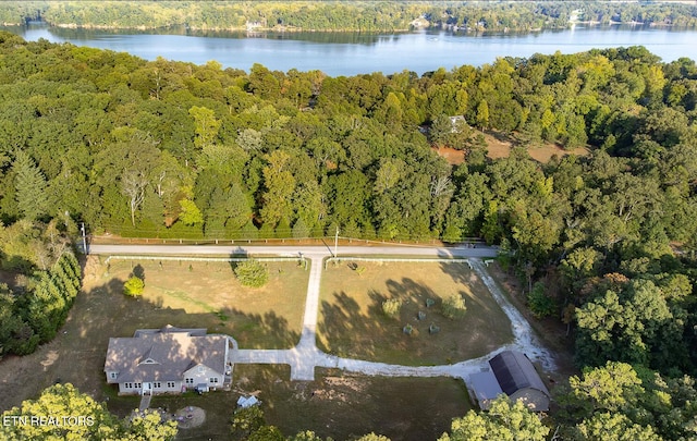 aerial view with a water view and a forest view