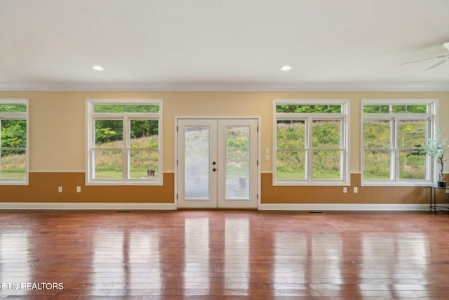 371 Pin Oak Dr, Rockwood, TN 37854 - unfurnished living room with wood-type flooring, plenty of natural light, crown molding, wainscoting, and french doors