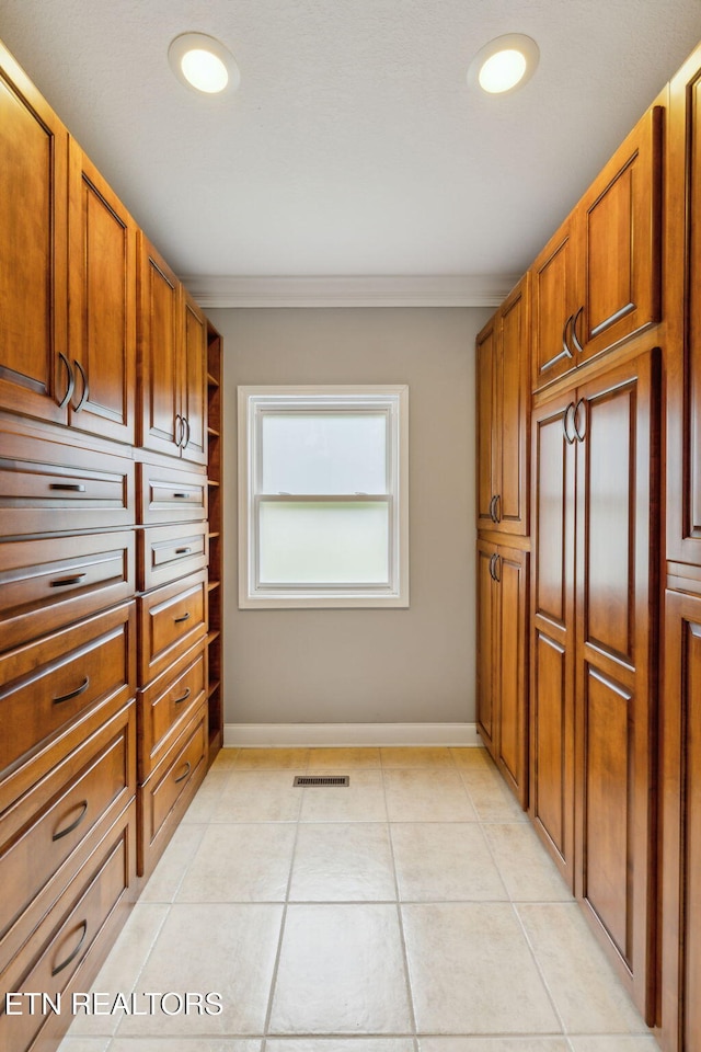 371 Pin Oak Dr, Rockwood, TN 37854 - kitchen featuring crown molding, light tile patterned floors, and brown cabinetry