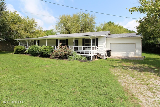 228 Pedigo Rd, Madisonville, TN 37354 - view of front facade with a porch, a garage, driveway, a front yard, and a metal roof