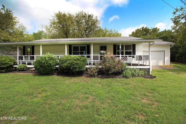 228 Pedigo Rd, Madisonville, TN 37354 - view of front facade featuring a porch, a garage, a front yard, and a metal roof