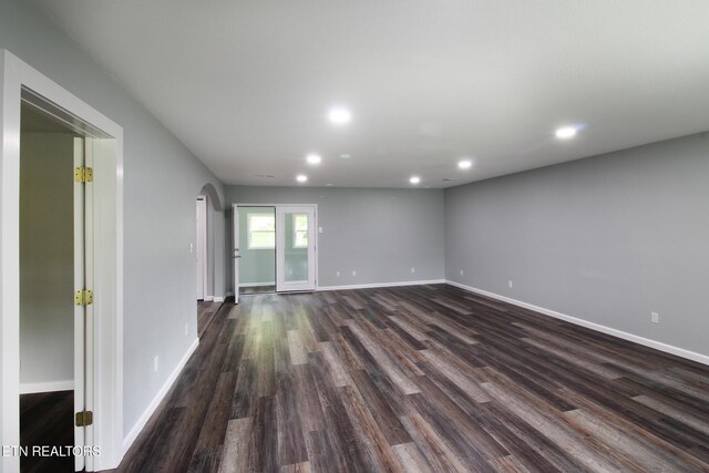 228 Pedigo Rd, Madisonville, TN 37354 - unfurnished room with arched walkways, recessed lighting, and dark wood-style flooring