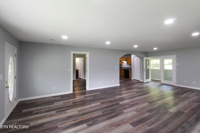 228 Pedigo Rd, Madisonville, TN 37354 - unfurnished living room with arched walkways, recessed lighting, and dark wood finished floors