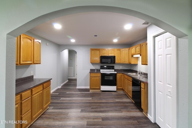 228 Pedigo Rd, Madisonville, TN 37354 - kitchen featuring black appliances, arched walkways, dark countertops, dark wood-type flooring, and recessed lighting