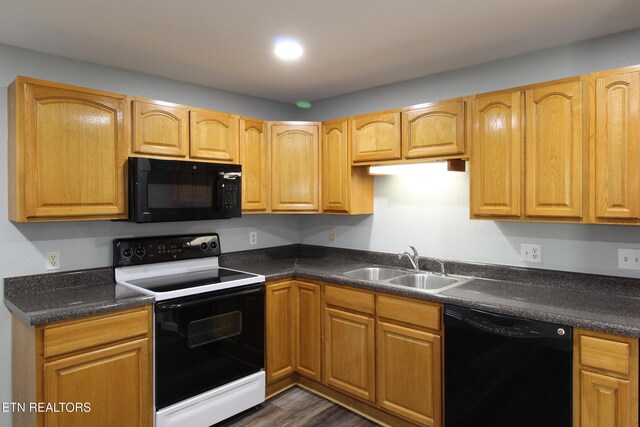 228 Pedigo Rd, Madisonville, TN 37354 - kitchen with black appliances, dark countertops, and dark wood-style flooring