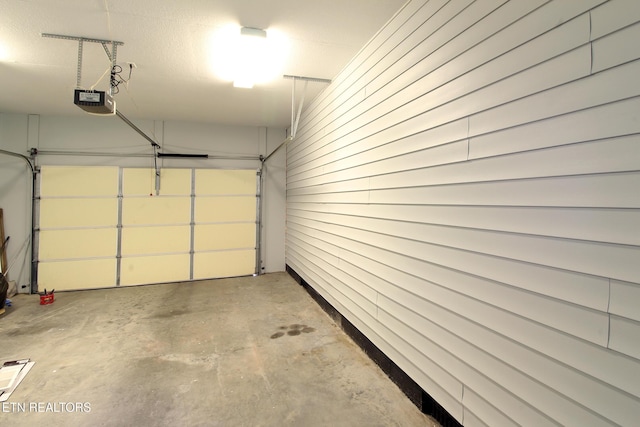 228 Pedigo Rd, Madisonville, TN 37354 - garage with a garage door opener and wooden walls