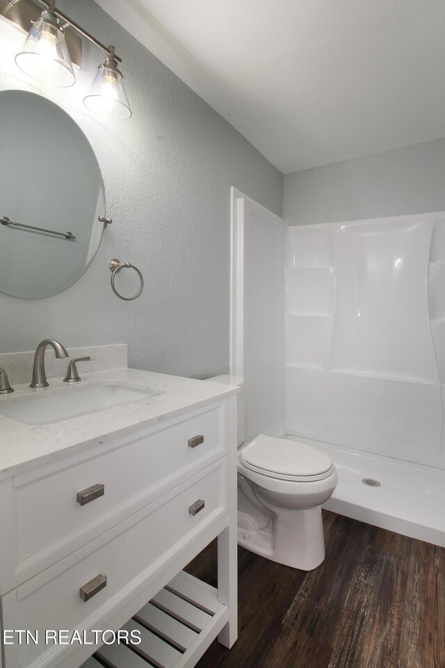 228 Pedigo Rd, Madisonville, TN 37354 - full bathroom featuring vanity, wood finished floors, a shower, and a textured wall
