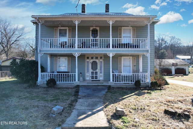 front facade with a balcony and a porch