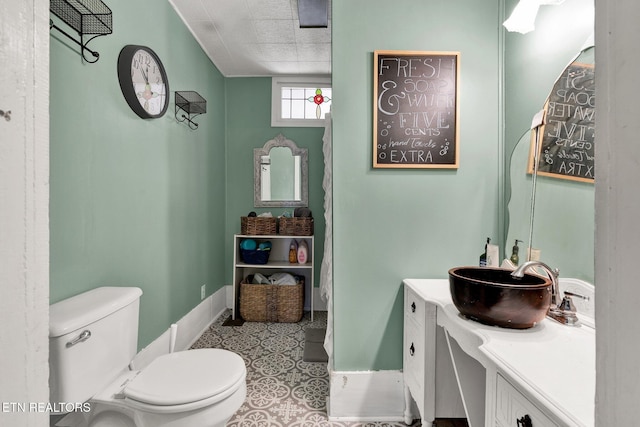 bathroom with toilet, tile patterned flooring, and vanity