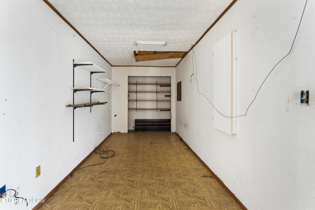 basement featuring dark parquet flooring, a textured ceiling, and electric panel