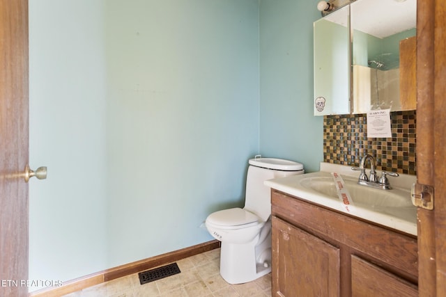 bathroom with decorative backsplash, toilet, vanity, and walk in shower