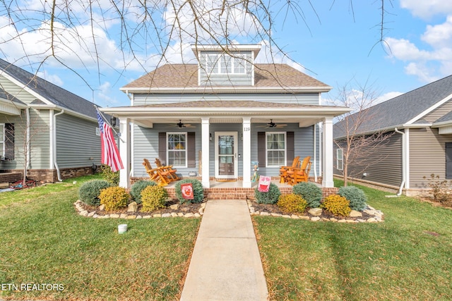 bungalow-style house with covered porch, ceiling fan, and a front lawn