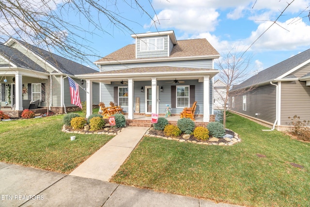 view of front of home with a front lawn, a porch, and ceiling fan