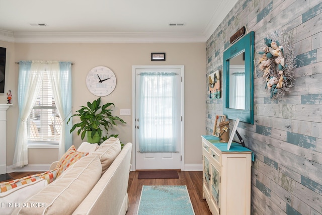 doorway featuring dark hardwood / wood-style floors, crown molding, and wood walls