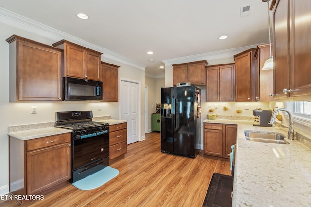 kitchen with light hardwood / wood-style floors, sink, black appliances, and crown molding