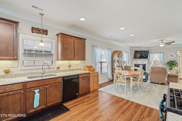 kitchen featuring pendant lighting, black dishwasher, a healthy amount of sunlight, sink, and crown molding