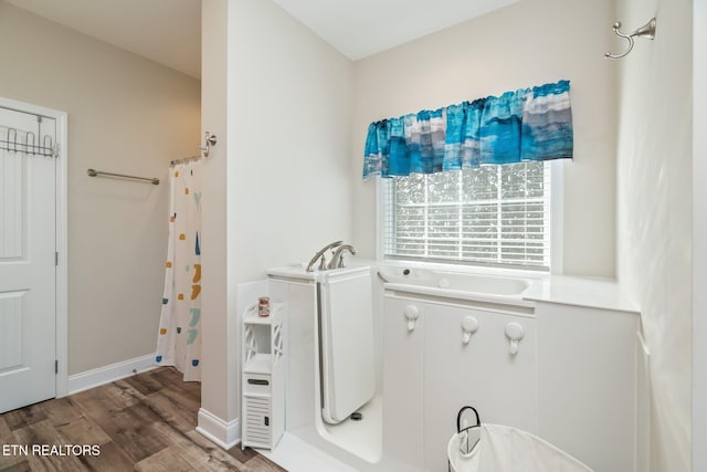 bathroom featuring shower with separate bathtub and hardwood / wood-style flooring