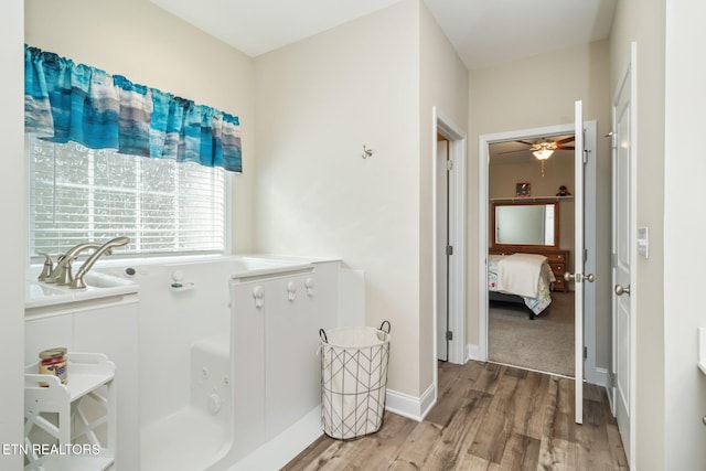 bathroom with ceiling fan and wood-type flooring