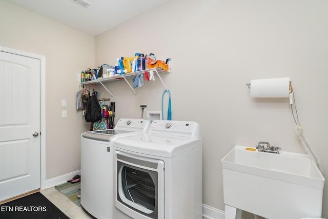 laundry room featuring sink and washer and clothes dryer