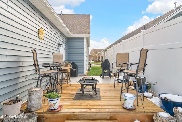 wooden terrace with an outdoor fire pit