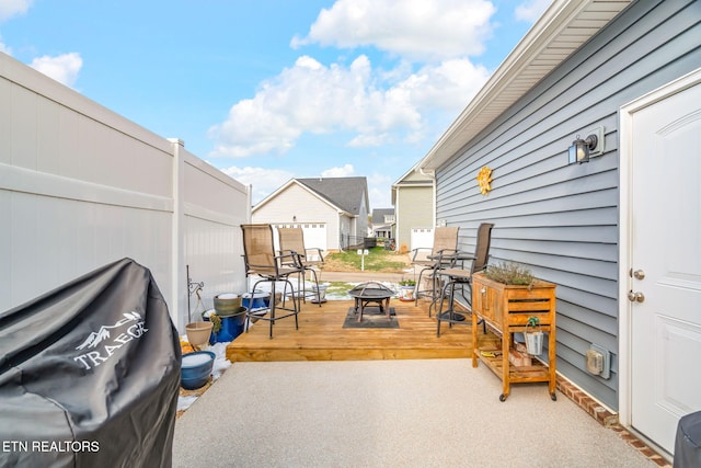 view of patio / terrace featuring a deck and a fire pit