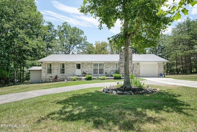 ranch-style house featuring a front yard and a garage